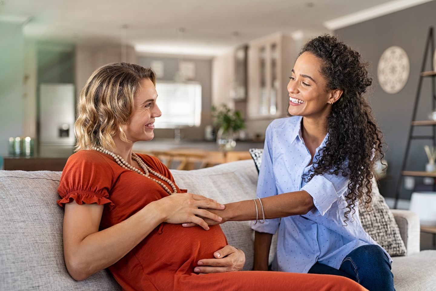 Cheerful,African,Friend,Feeling,Belly,Bump,Of,Pregnant,Woman.,Happy