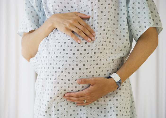 Pregnant woman in hospital gown